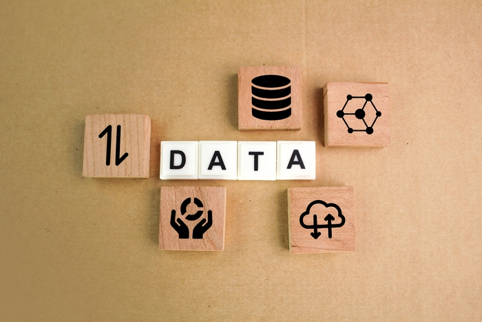 Wooden blocks spelling DATA with database, network and cloud icons. Stock photography for illustrative context, not a Techloom product or customer system.