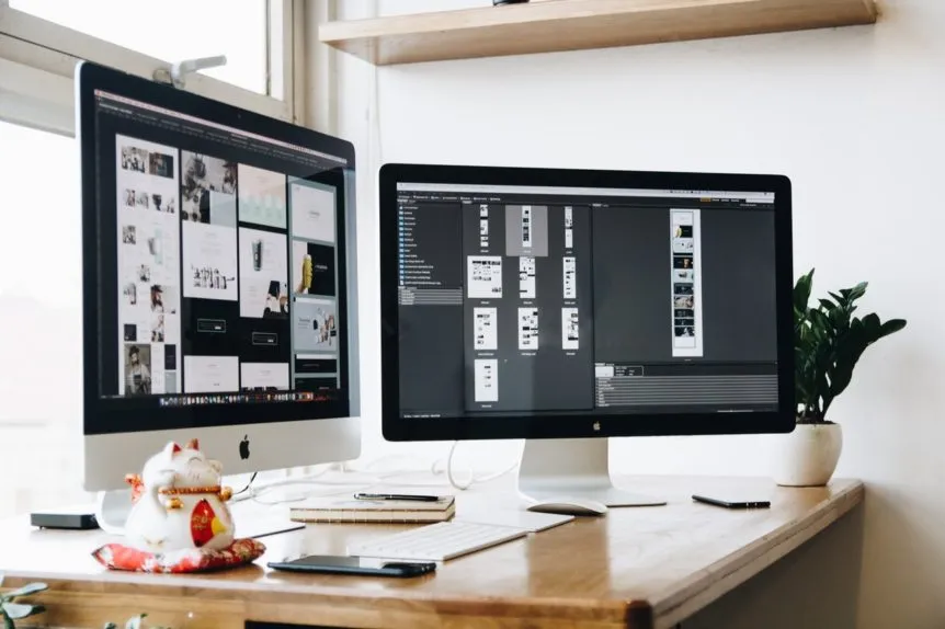 Two business computers on a desk. Stock photography for illustrative context, not Techloom staff or a Techloom office.