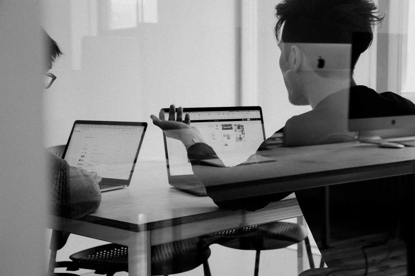 Team reviewing plans on a board. Stock photography for illustrative context.
